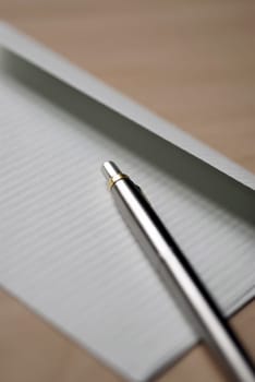 Close_up of a ballpoint pen on a sheet of paper