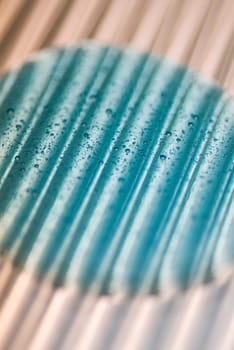 Close_up of water drops on a blue surface
