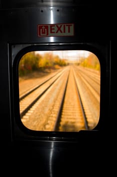 Railroad track viewed through the window of a train