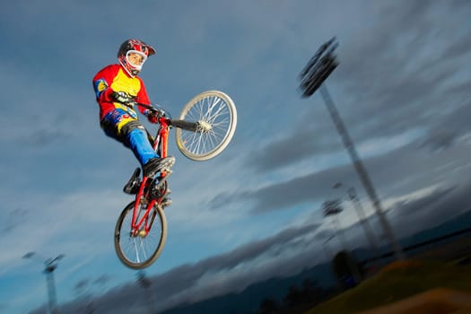 Low angle view of a BMX cyclist performing in mid_air