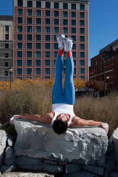 Man exercising on a stone