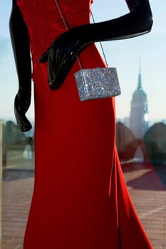 Mid section view of a mannequin in a store with a skyscraper in the background, Empire State Building, Manhattan, New York City, New York State, USA