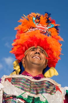 Portrait of a mid adult man performing traditional dance and smiling