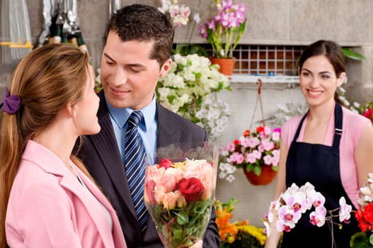 Couple romancing at a flower shop