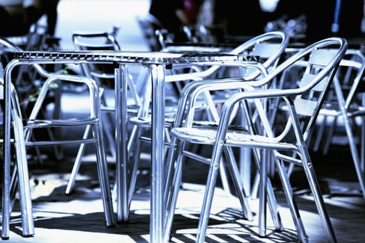 Close_up of an empty table and chairs in a sidewalk cafe