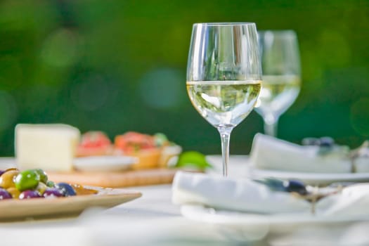 Wine glass with olives on a table