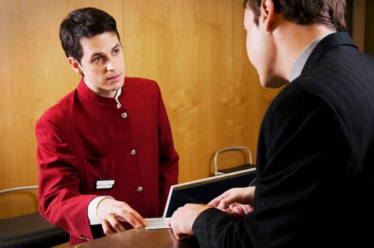 Businessman checking a card at hotel reception