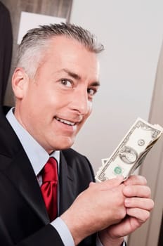 Businessman holding currency notes in a clothing store