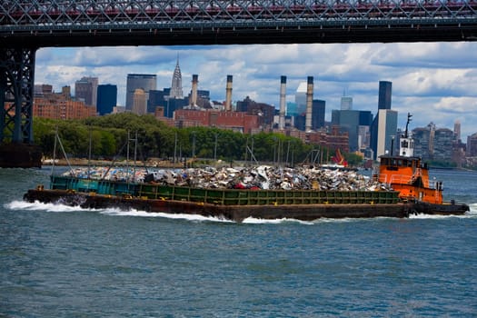 Tugboat carrying garbage in the river, Hudson River, Manhattan, New York City, New York State, USA