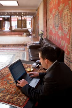 High angle view of a businessman using a laptop in a restaurant