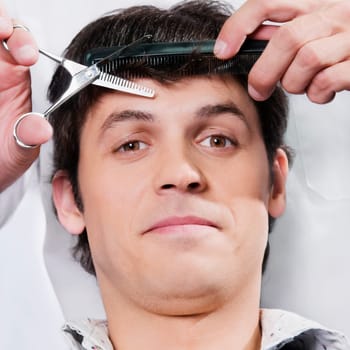 Man receiving a haircut in a salon
