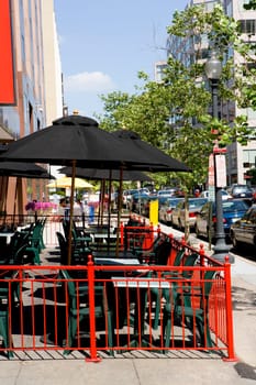 Tables and chairs at a sidewalk cafe in a city, Washington DC, USA