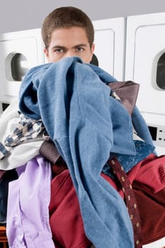 Man carrying a basket in a laundromat
