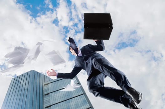 Low angle view of a businessman jumping in air