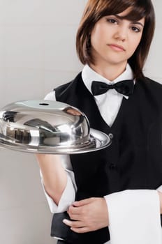 Portrait of waitress holding a domed tray