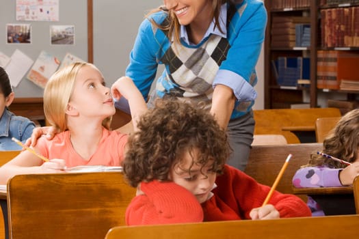 Students with their teacher in a classroom