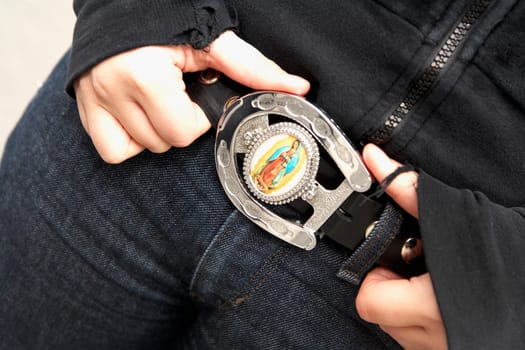 Close_up of a young woman holding her belt