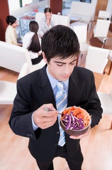 Businessman eating salad in a restaurant
