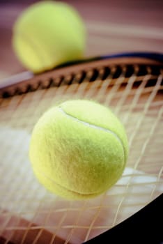 Close_up of tennis balls and a tennis racket