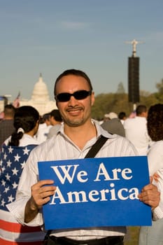 Mid adult man holding a signboard and smiling