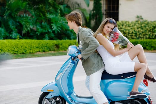 Couple sitting on a moped, Biltmore Hotel, Coral Gables, Florida, USA