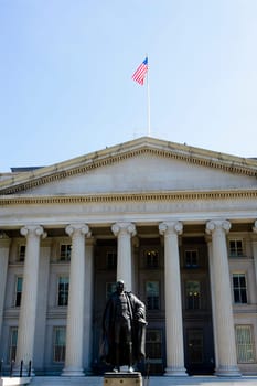 Statue of Alexander Hamilton in front of a government building, US Treasury Department, Washington DC, USA