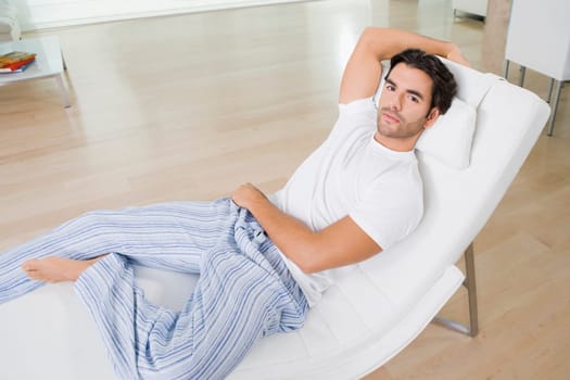 Portrait of a young man resting on a reclining chair