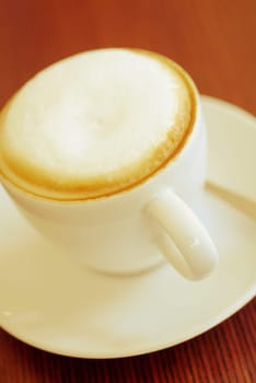 Close_up of a cup of cappuccino on a saucer