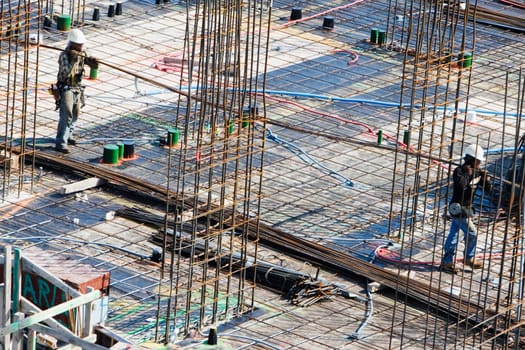 High angle view of two construction workers working at a construction site