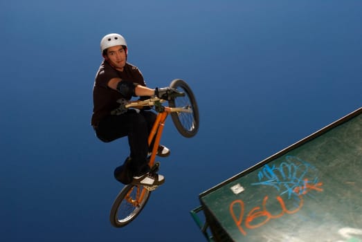 Portrait of a BMX cyclist performing in mid_air