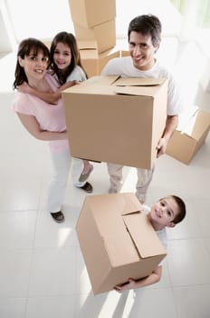 High angle view of a family carrying cardboard boxes