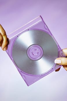 Close_up of a man and a woman holding a compact disc