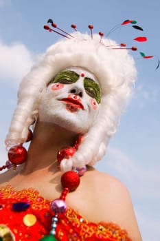 Low angle view of a gay man with face paint on his face