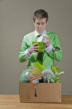 Fired businessman picking a tissue paper