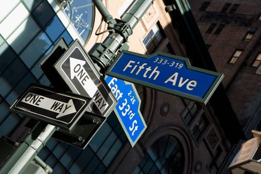 Low angle view of street name signs on a pole, Fifth Avenue, Manhattan, New York City, New York State, USA