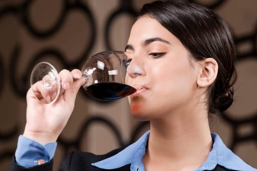 Businesswoman drinking wine