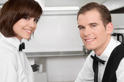 Portrait of a male and a female waiters smiling