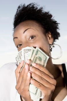 Portrait of a young woman holding banknotes