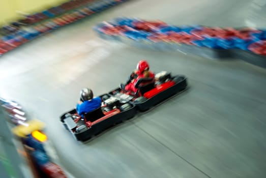 High angle view of two people go_carting on a motor racing track