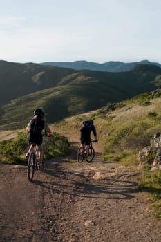 Rear view of a couple mountain biking