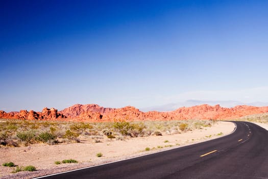 Road passing through an arid landscape, Las Vegas, Nevada, USA