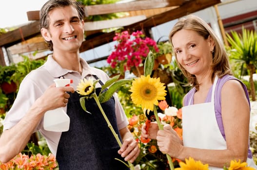 Woman and a man working in a greenhouse