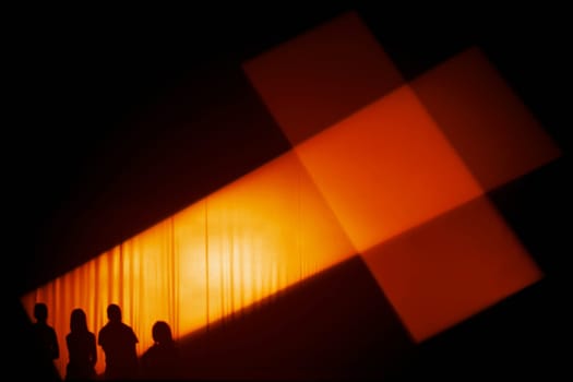 Silhouette of people with Catholic cross