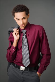 Portrait of a businessman carrying his coat over his shoulder and smiling