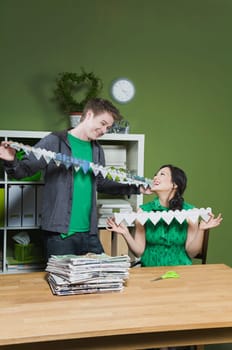 Man and a woman holding paper chains