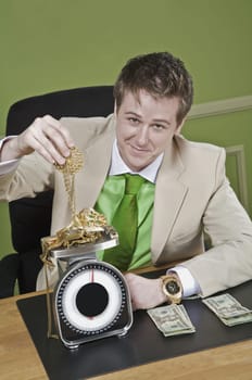 Businessman weighing gold jewelry