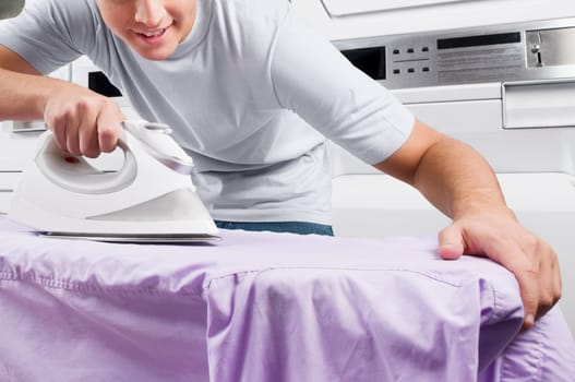Man ironing in a laundromat