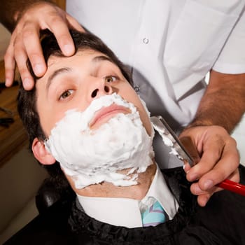Man getting shaved in a salon
