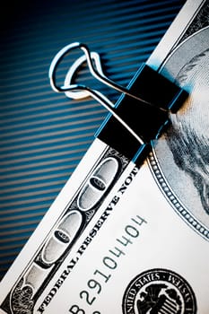 Close_up of a one hundred dollar bill in a paper clip