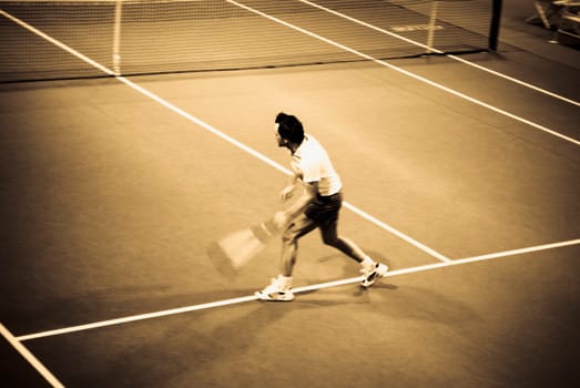 High angle view of a man playing tennis in a court